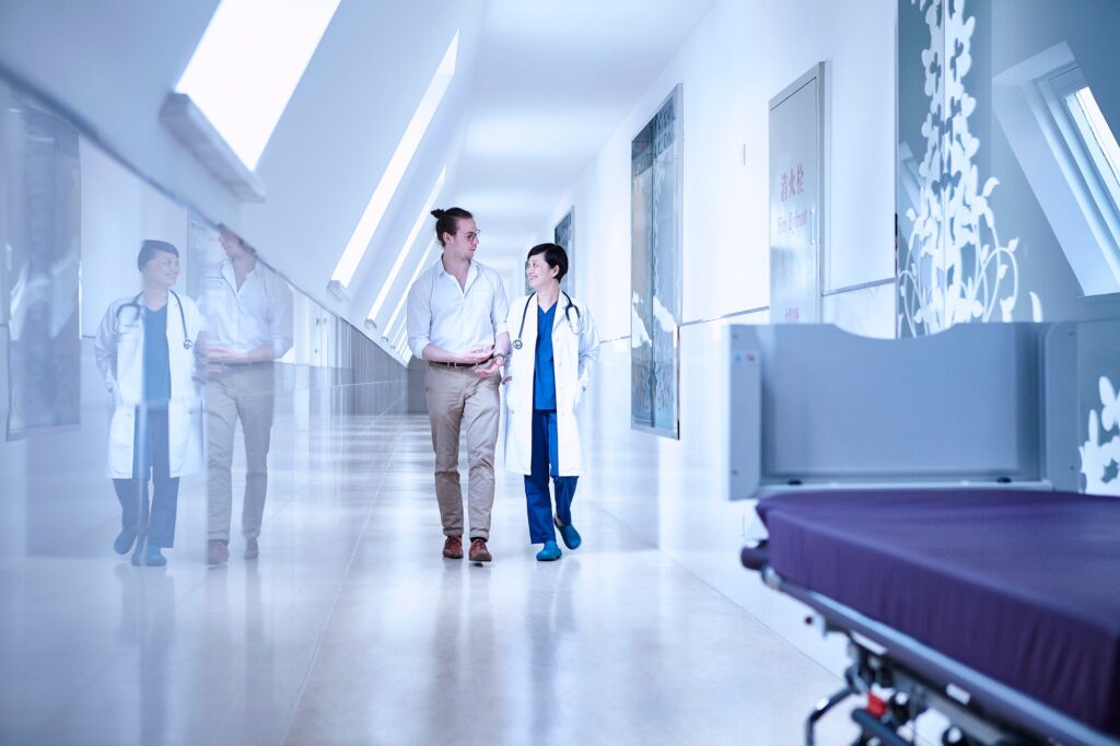 Doctors walking in hospital corridor