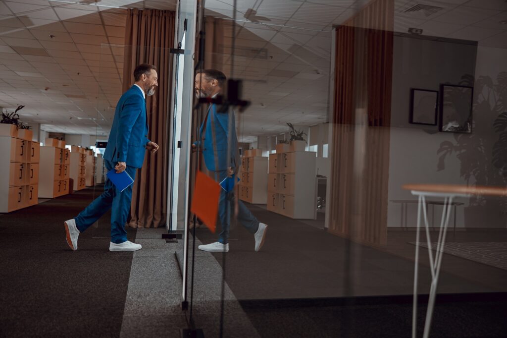 Positive man in a suit following in the negotiation room